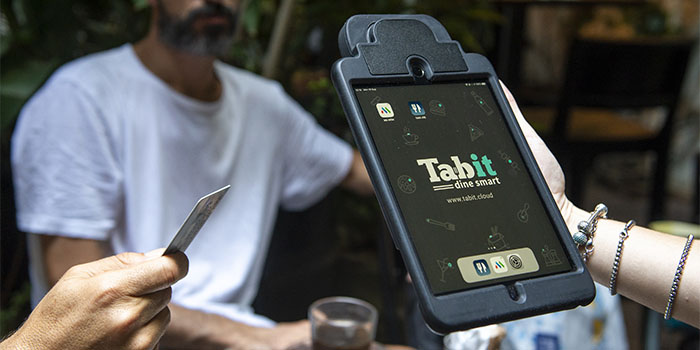 person holding a Tabit display