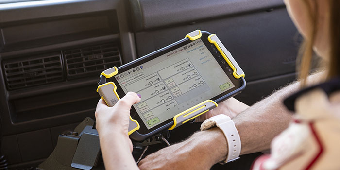 person holding tablet with gray and yellow mount
